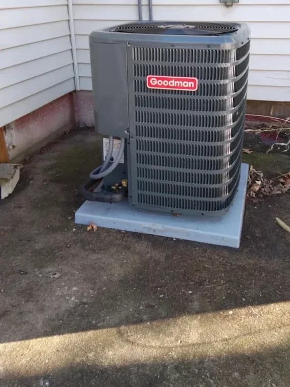 A newly installed outdoor unit standing on a level pad beside a home