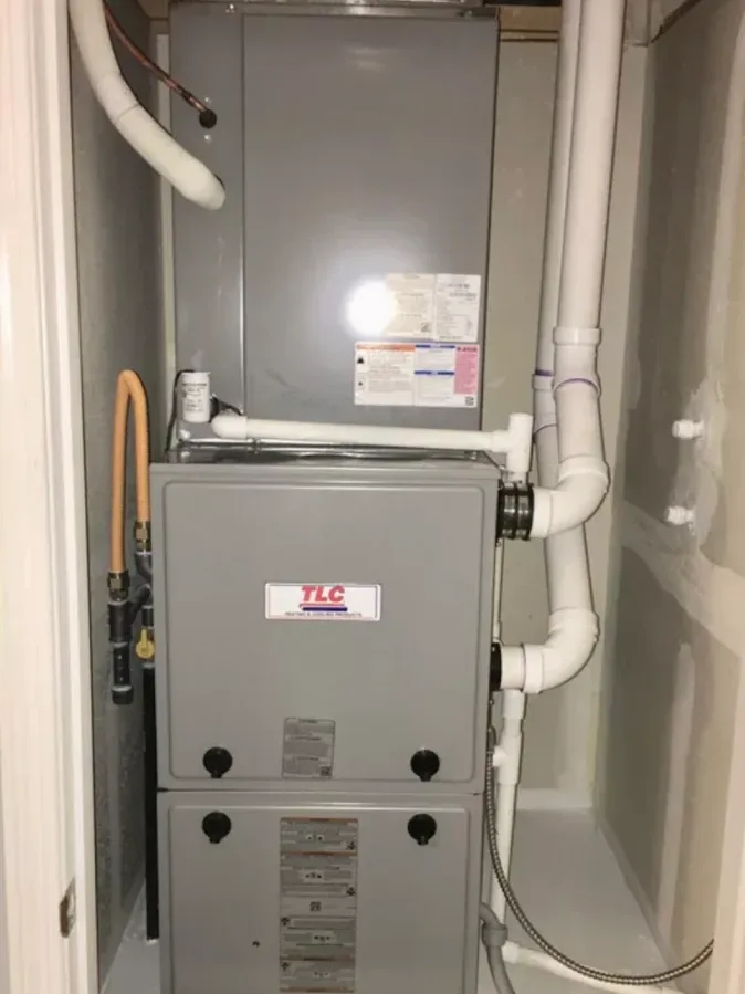 A gas furnace and its venting installed in a home utility closet